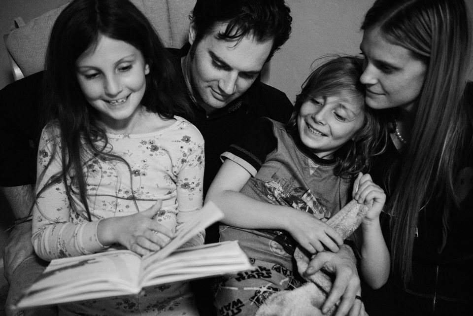 print family photos in a book man woman girl boy reading